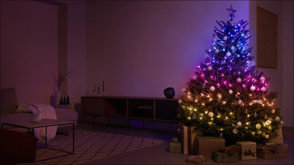 A Christmas tree lit up with strands of Philips Signify holiday lights.