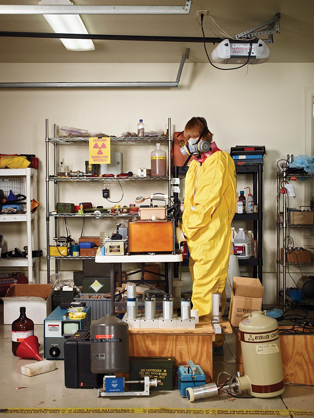 Taylor Wilson in a hazmat suit and gas mask in his nuclear lab