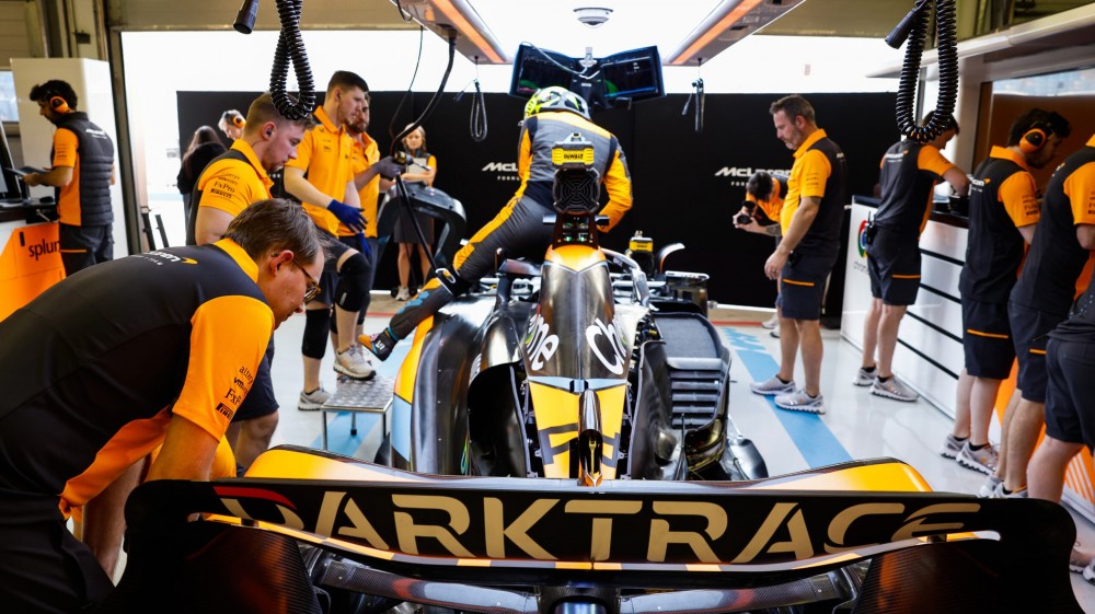 McLaren team members work on the Lando Norris McLaren MCL60 in the garage